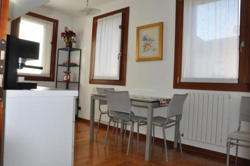 a kitchen with a table and chairs in a room at Ex Casa degli Artisti in Montebelluna