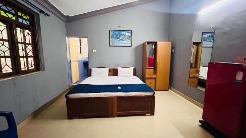 a bedroom with a bed in the corner of a room at Harsh angel holiday homes in Calangute
