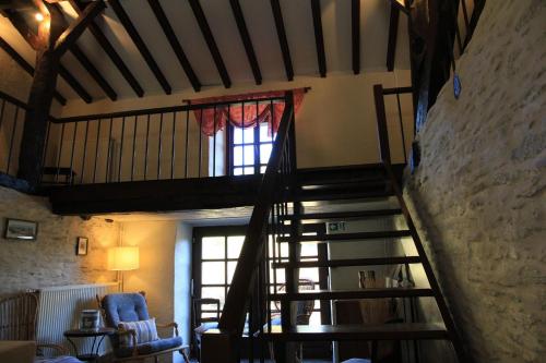 a spiral staircase in a room with a window at Gîte écologique 14 pers. à Taverneux - Houffalize in Houffalize
