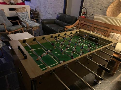 a large pool table with avertisement for at Gîte écologique 14 pers. à Taverneux - Houffalize in Houffalize