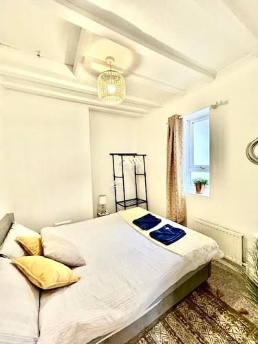 a bedroom with a large bed and a window at Saxon Cottage St Leonards on sea in Hastings