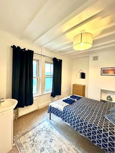 a bedroom with a bed and a sink at Saxon Cottage St Leonards on sea in Hastings