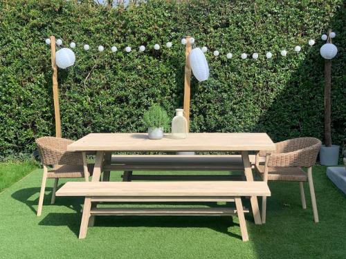 a picnic table with two chairs and a bench at Beach house & garden in idyllic village location in West Wittering