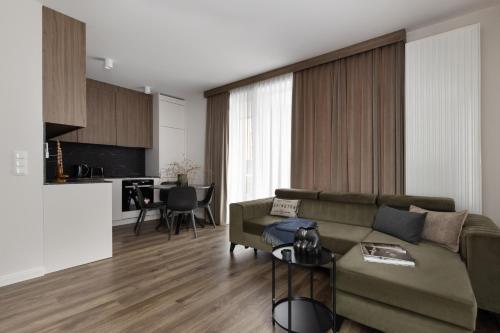 a living room with a couch and a table at Scala Apartamenty by Moderna Profit- Łąkowa 60K in Gdańsk