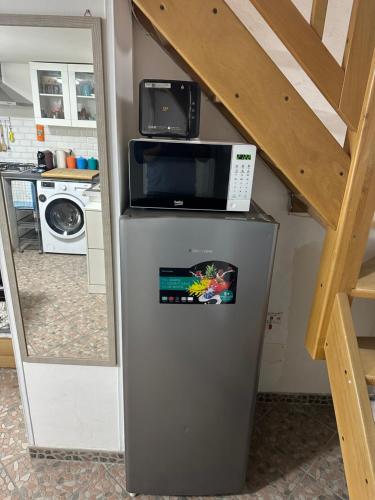 a microwave on top of a refrigerator in a kitchen at Itaca in Lipari