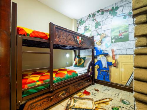 a childs bedroom with two bunk beds and a mural at LEGOLAND(R) Windsor Resort in Windsor