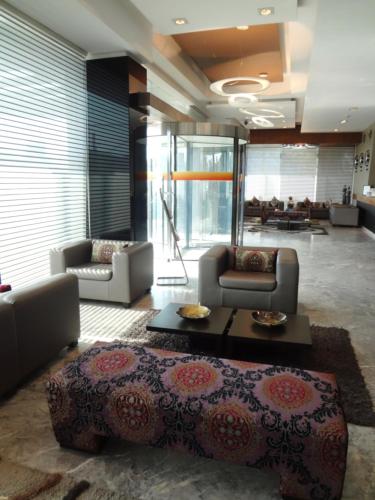 a living room with a couch and a coffee table at Hotel Suba International Sahar Road Mumbai in Mumbai