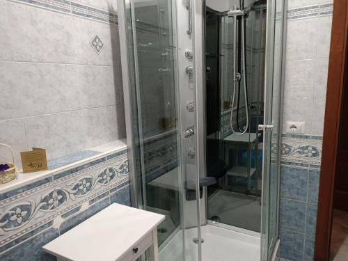 a shower with a glass door in a bathroom at monolocale speedy in Fiumicino