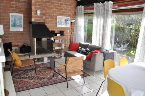 a living room with a couch and a fireplace at Boerenslag 22 in Sint Maartensvlotbrug