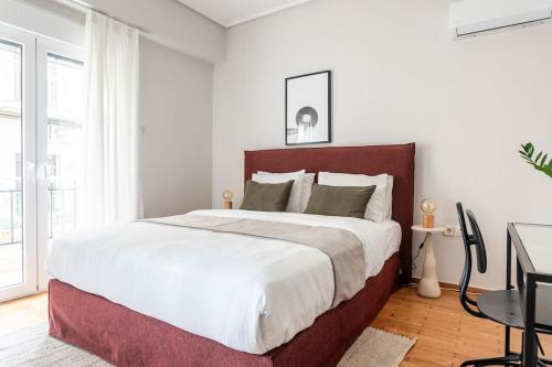 a bedroom with a large bed and a desk at Comfy 1BR Apartment in Ampelokipoi by UPSTREET in Athens