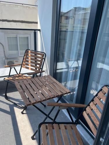 two chairs and a wooden bench on a balcony at Camelia 12 1+1 on Cleopatra with partly seaview in Alanya