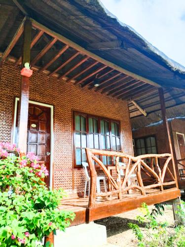 a wooden bench in front of a brick house at Jurisu Resort in San Vicente