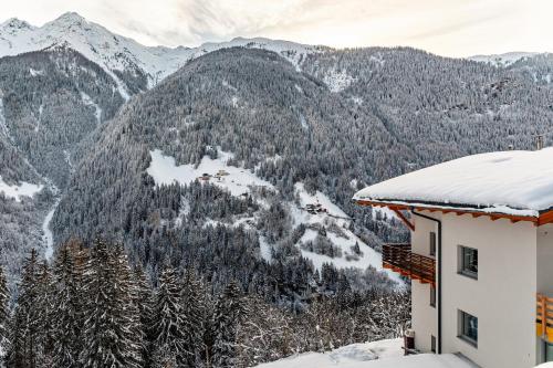 a house with snow on the roof of a mountain at Apart Erna in See