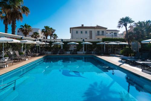 a large swimming pool with chairs and umbrellas at THB Gran Playa - Adults Only in Can Picafort