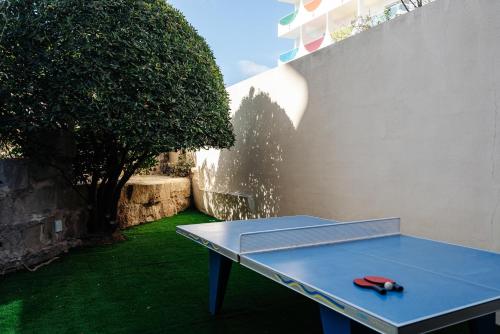 a blue ping pong table with a red pair of scissors on it at THB Maria Isabel - Adults Only in Playa de Palma