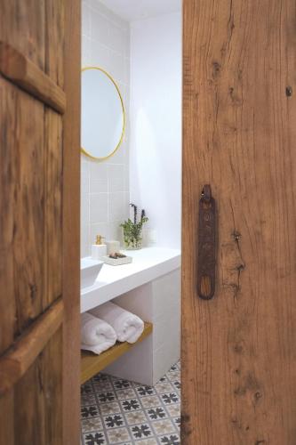 a bathroom with a sink and a mirror at Arta Hydra in Hydra