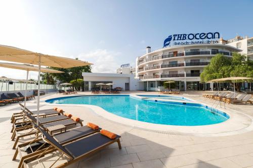 una piscina con sedie a sdraio e un hotel di THB Ocean Beach a Baia di Sant'Antoni