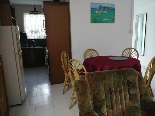 a kitchen and dining room with a table and chairs at Les Filaos De Pereybere in Pereybere