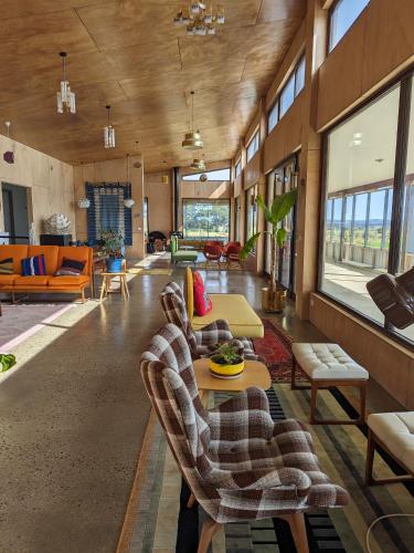 a living room with couches and a table at Farmstay in Central Victoria in Ballan