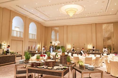 a banquet hall with tables and people in a building at Hotel Adlon Kempinski Berlin in Berlin