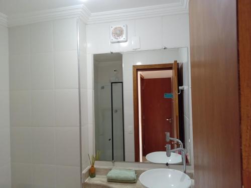 a bathroom with two sinks and a large mirror at Antonia Haddad in Lorena