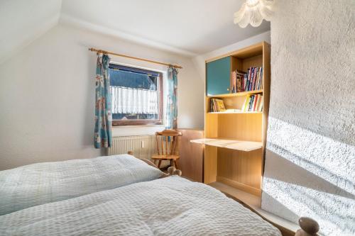 a bedroom with a bed and a book shelf at Ferienwohnung Frechehof 136 qm in Bad Peterstal-Griesbach