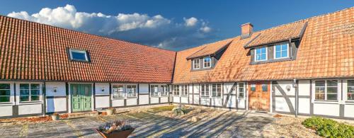 a row of buildings with red roofs at Farhults Garden in Farhult