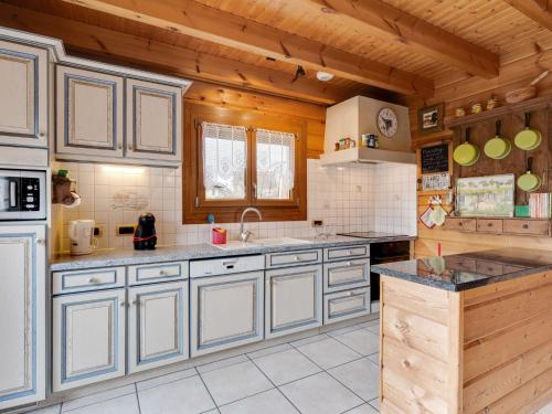 a kitchen with wooden walls and a wooden ceiling at Spacious Chalet in Abbevillers with Swimming Pool in Abbévillers