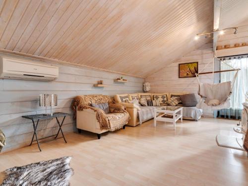 a living room with two couches and a table at Spacious Chalet in Abbevillers with Swimming Pool in Abbévillers
