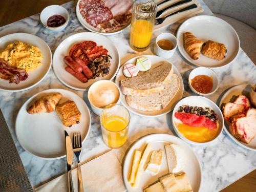 a table topped with plates of breakfast foods and drinks at TRIBE Lyon Croix Rousse in Lyon