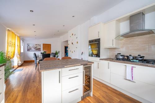 a kitchen with white cabinets and a counter top at *RA98BL* For your most relaxed & Cosy stay + Free Parking + Free Fast WiFi * in Farnley