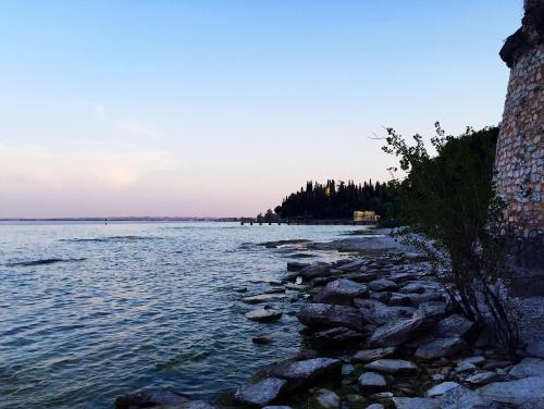 a rocky shore of a body of water at Hotel Ca' Serena in Sirmione