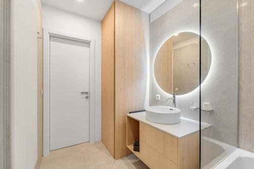 a bathroom with a sink and a mirror at On the Danube, city center, free parking in Bratislava
