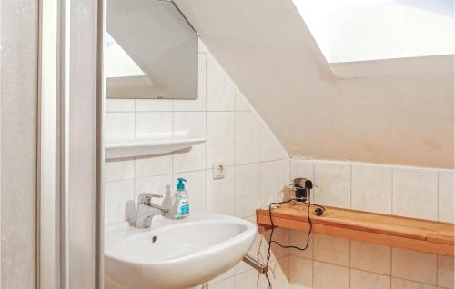 a bathroom with a sink and a mirror and a staircase at Nice Home In Ebensee With Ethernet Internet in Ebensee