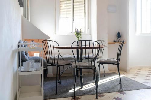 een eettafel en stoelen in een kamer bij Azafran Jerez apartamentos in Jerez de la Frontera