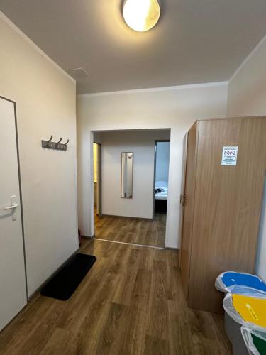 an empty room with a hallway with a door at Apartament, Pokoje Koniczynka in Karpacz