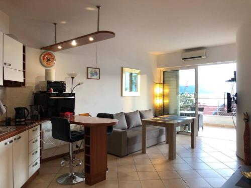 a kitchen and living room with a couch and a table at Boka Residence 7 in Herceg-Novi