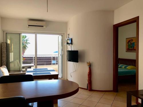 a living room with a table and a view of the ocean at Boka Residence 7 in Herceg-Novi