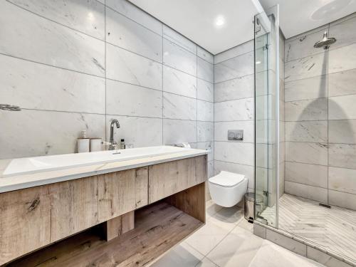 a bathroom with a tub and a shower and a toilet at Studio with ocean and promenade view Sea point in Cape Town