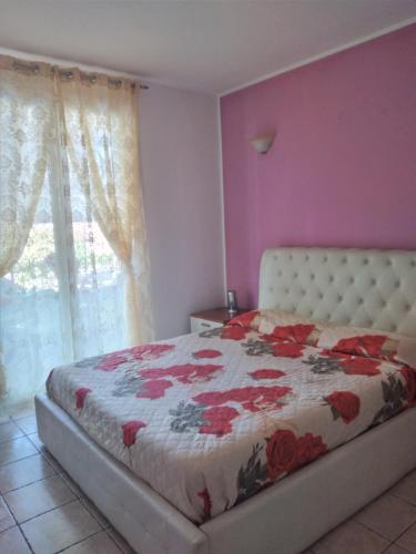 um quarto com uma cama com colcha floral em Casa puntone em Puntone di Scarlino
