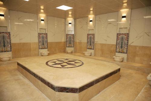 a large room with a stone floor with a design on it at Rush Hotel Tokat in Tokat