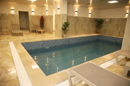 a large swimming pool in a hotel room at Rush Hotel Tokat in Tokat