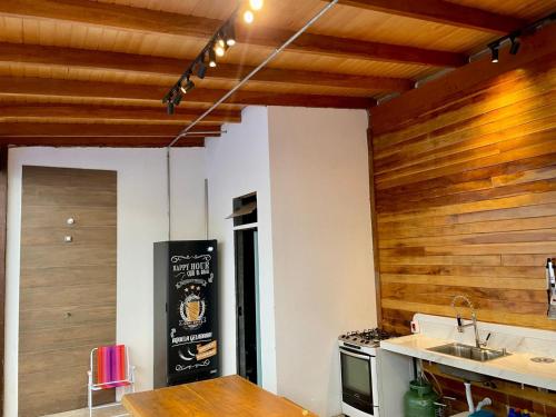 a kitchen with wooden walls and a counter and a sink at Unidades mobiliadas em condomínio in Lucas do Rio Verde