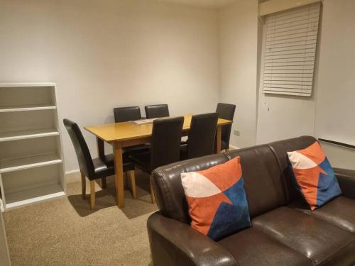 a living room with a couch and a table with chairs at Superb 2Bed/2Bath Flat Waterloo London in London