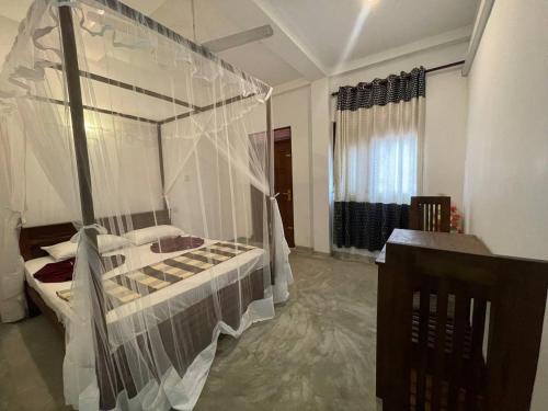 Ένα ή περισσότερα κρεβάτια σε δωμάτιο στο Villa Sunimal