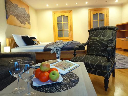 a living room with a table with a plate of fruit at Old Town Center Spacious Loft Apartment, up to 4 guests in Rīga