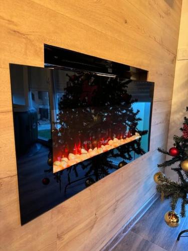 a fireplace with a christmas tree inside of it at Family House Maksimović in Valjevo