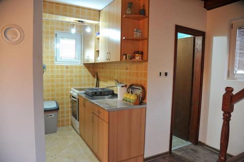 a small kitchen with a sink and a stove at Family House Maksimović in Valjevo