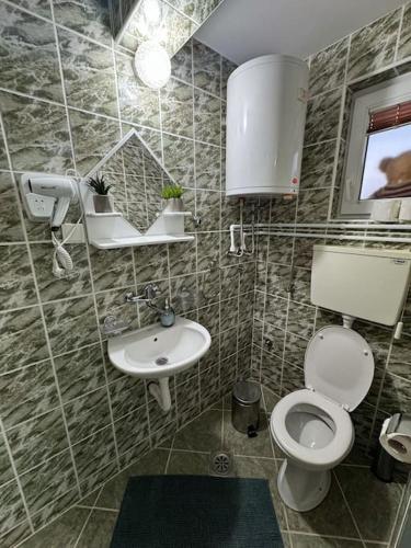 a bathroom with a toilet and a sink at Family House Maksimović in Valjevo