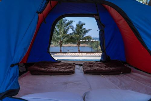 a blue and red tent with two beds in it at Off The Grid Glamps in Khopoli